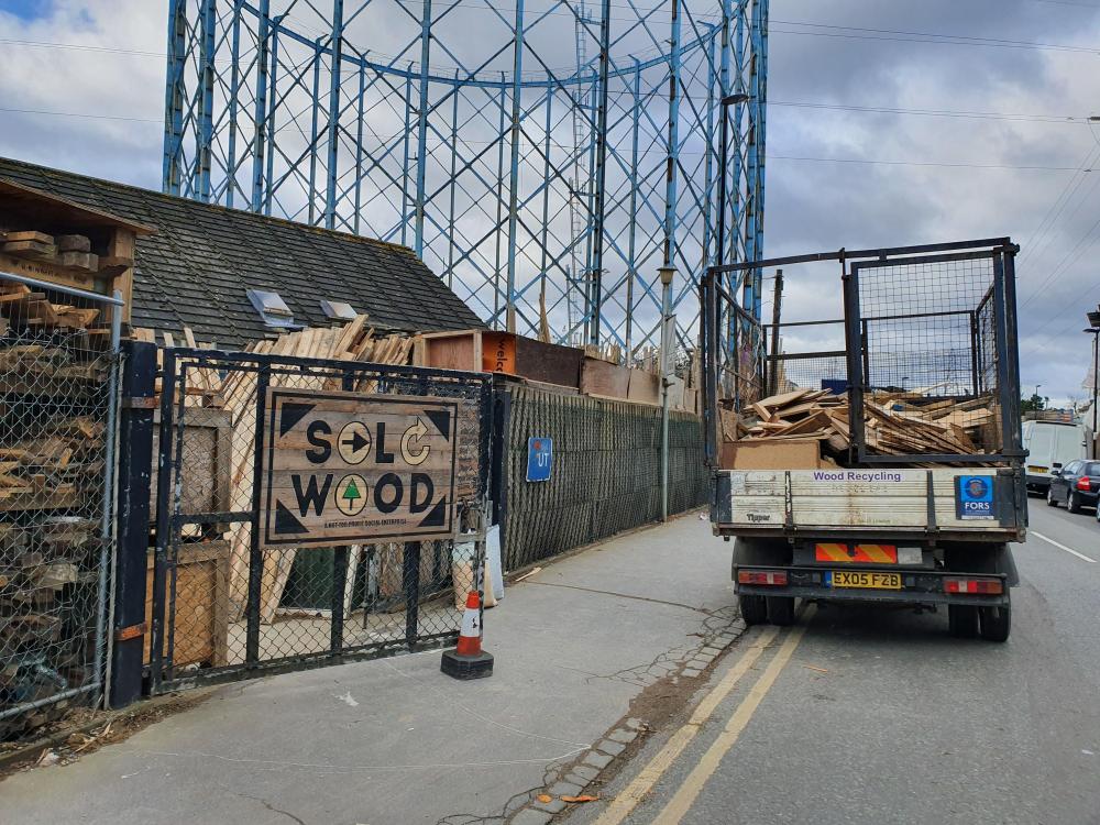 recycling entry with car full of wood rot for biomass 