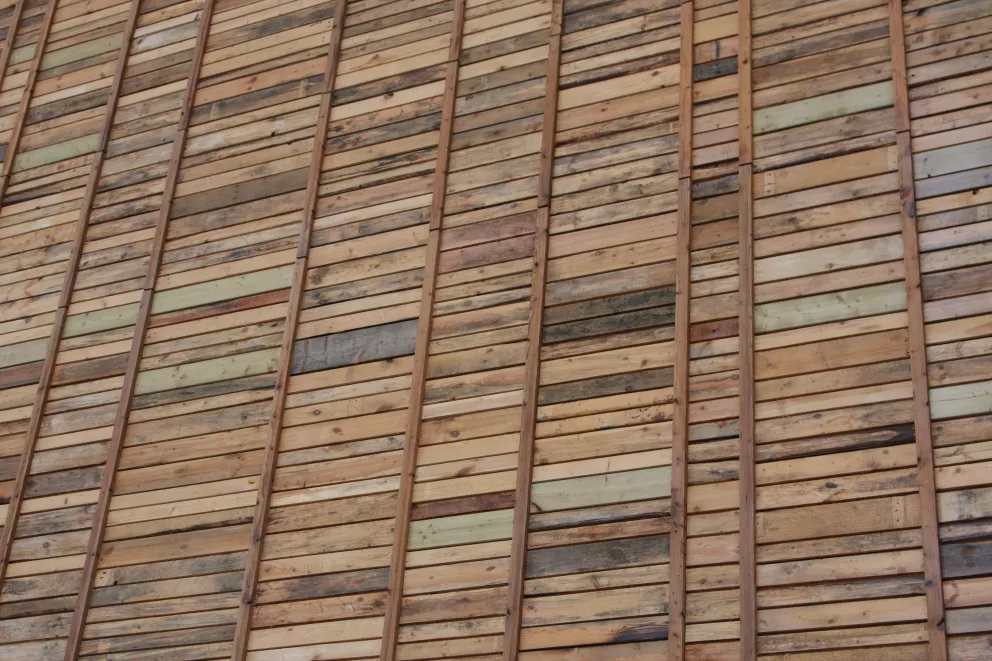Les façades des bâtiments existants sont revêtues de planches de bois de démolition.
